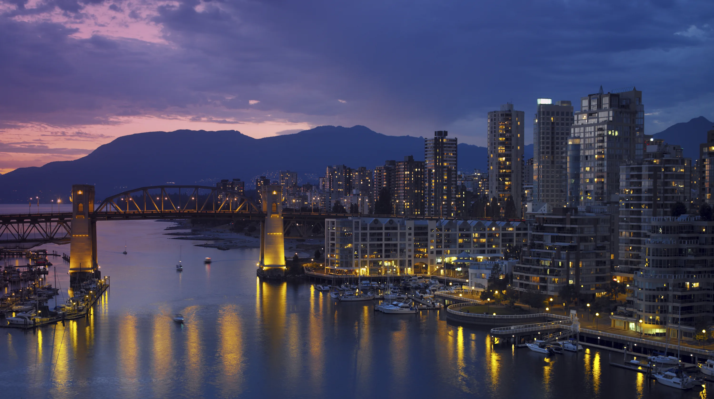 Vancouver skyline and Burrard Bridge over False Creek at dusk